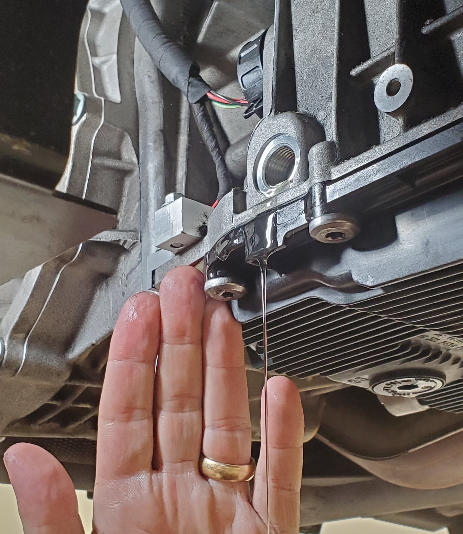 Automatic transmission fluid dribbling out of the fill plug hole in an Aston Martin DB9