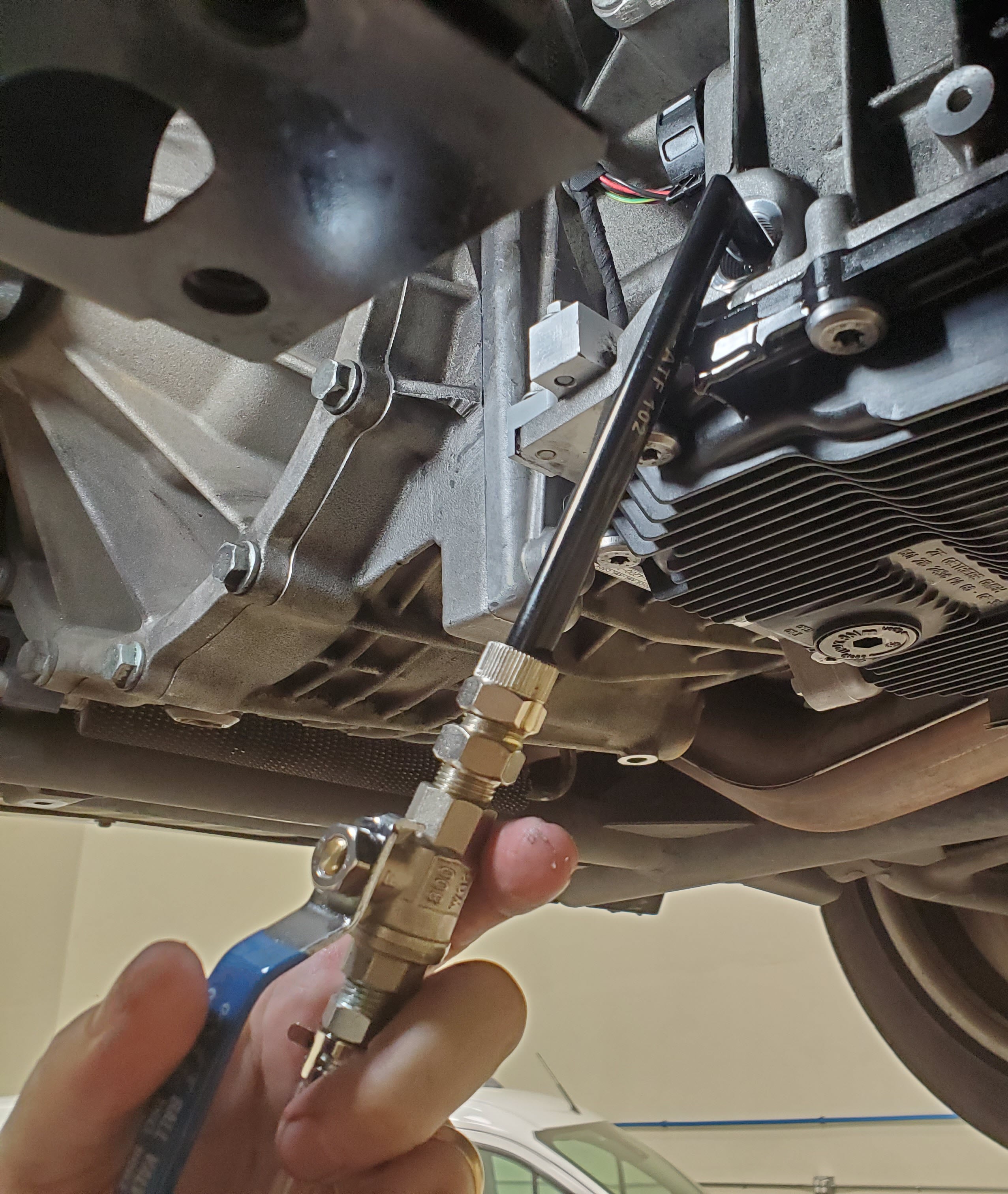 Automatic transmission fluid pump in the fill hole of an Aston Martin DB9