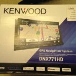 Removing the factory radio from a Ford Flex dashboard using panel removal tools