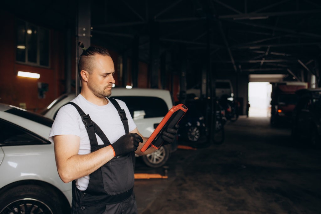Mechanic Using Tablet On Car